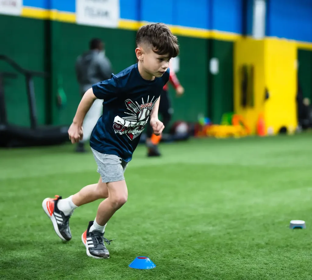 young boy learning football techniques metro east